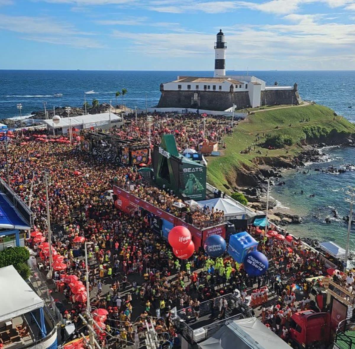 Salvador Carnival crowds beside the Farol da Barra lighthouse, Bahia